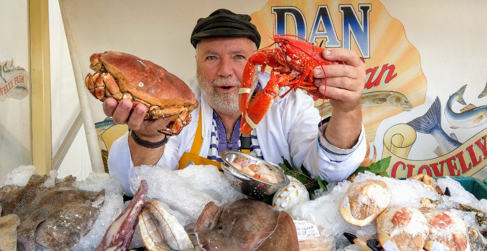 Dan the Fish Man holding fresh seafood at Plymouth Seafood and Harbour Festival